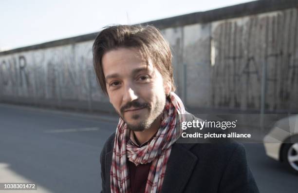 67th International Film Festival in Berlin, Germany, 14 February 2017. Mexican director Diego Luna stands by a remaining section of the Berlin Wall...