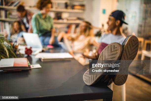 close up of sole of man's shoe resting on the table. - disrespect imagens e fotografias de stock