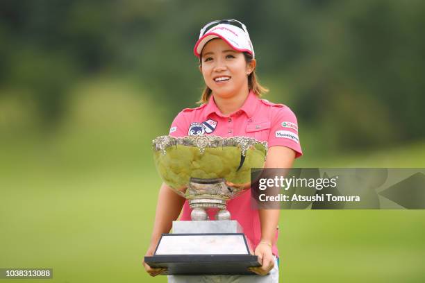 Kaori Oe of Japan poses with the trophy after winning the Miyagi TV Cup Dunlop Ladies Open at Rifu Golf Club on September 23, 2018 in Rifu, Miyagi,...