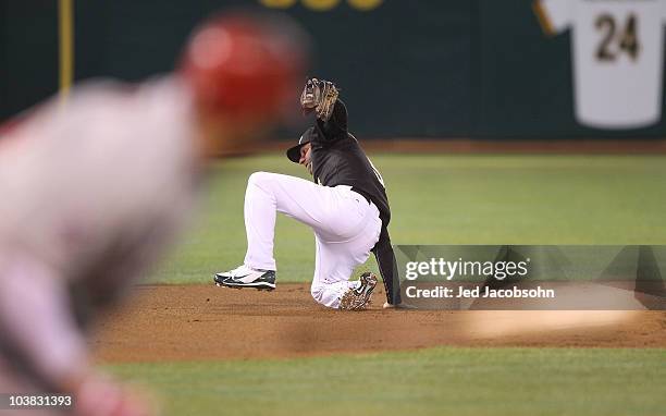 Juan Rivera of the Los Angeles Angels of Anaheim hits into a fielders choice as Kevin Kouzmanoff of the Oakland Athletics during a Major League...