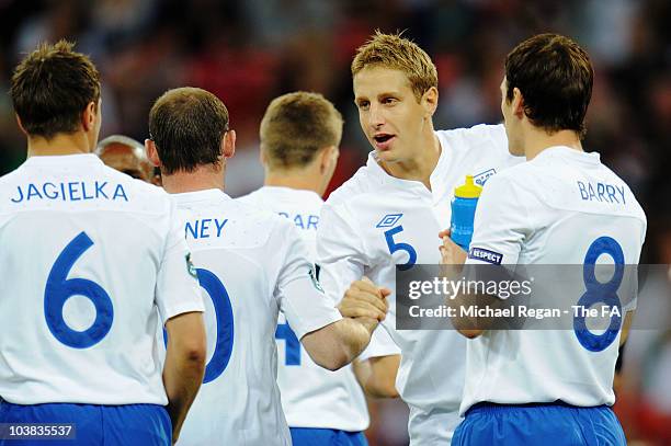 Michael Dawson of England talks to team mates ahead of the UEFA EURO 2012 Group G Qualifying match between England and Bulgaria at Wembley Stadium on...