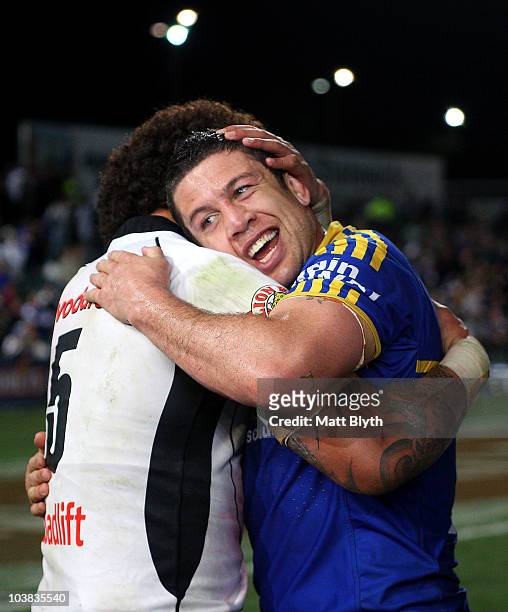 Nathan Cayless of the Eels is congratulated by Manu Vatuvei of the Warriors after playing his final game after round 26 NRL match between the...
