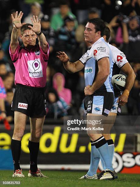 Referee Jason Robinson sends Grant Millington of the Sharks to the sin bin for fighting during the round 26 NRL match between the Penrith Panthers...