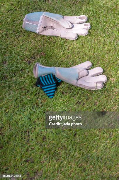 worn soccer goalkeeper sport gloves - sports glove stockfoto's en -beelden