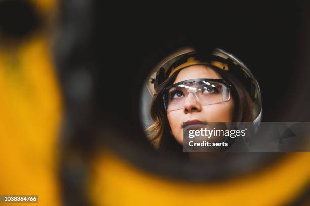 portrait of young beautiful engineer woman working in factory building. - factory wide angle stock pictures, royalty-free photos & images