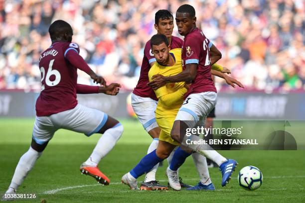 Chelsea's Belgian midfielder Eden Hazard vies with West Ham United's French defender Arthur Masuaku , West Ham United's Paraguayan defender Fabián...