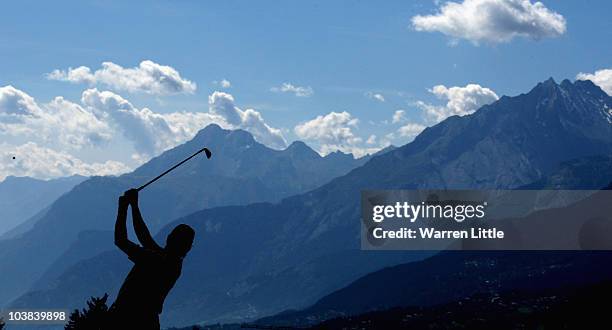 Miguel Angel Jimenez of Spain plays his second shot into the 14th green during the third round of The Omega European Masters at Crans-Sur-Sierre Golf...