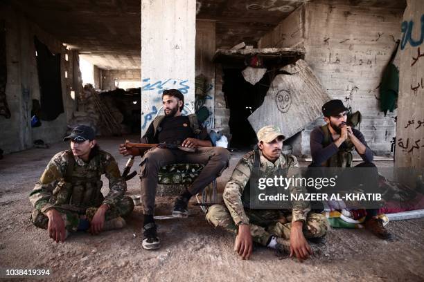 Fighters from the Nureddine al-Zinki unit, a moderate Syrian opposition faction affiliated with the Muslim Brotherhood and made up of former Syrian...