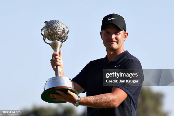 Tom Lewis of England poses for a photo with his trophy after winning during Day Four of the Portugal Masters at Dom Pedro Victoria Golf Course on...