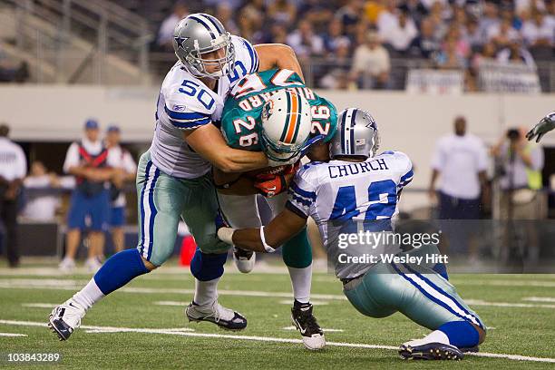 September 2: Linebacker Sean Lee and defensive back Barry Church of the Dallas Cowboys tackle running back Lex Hilliard of the Miami Dolphins at...