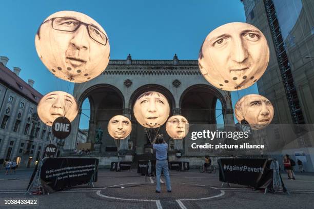 Ballons bearing the faces of the G7 members showing Japanese Prime Minister Shinzo Abe, French President Francois Hollande, Italian Prime Minister...