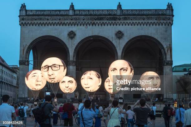 Ballons bearing the faces of the G7 members showing Japanese Prime Minister Shinzo Abe, French President Francois Hollande, Italian Prime Minister...