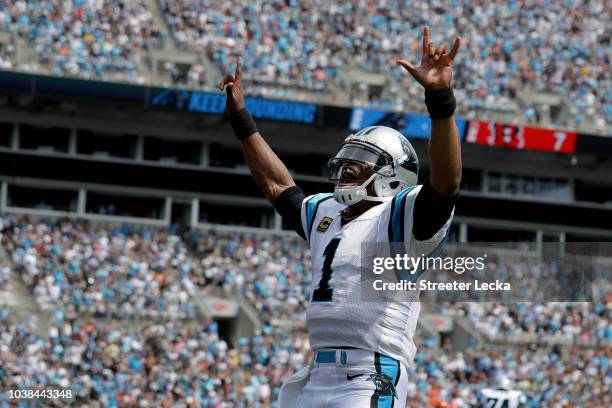 Cam Newton of the Carolina Panthers celebrates a touchdown against the Cincinnati Bengals in the first quarter during their game at Bank of America...