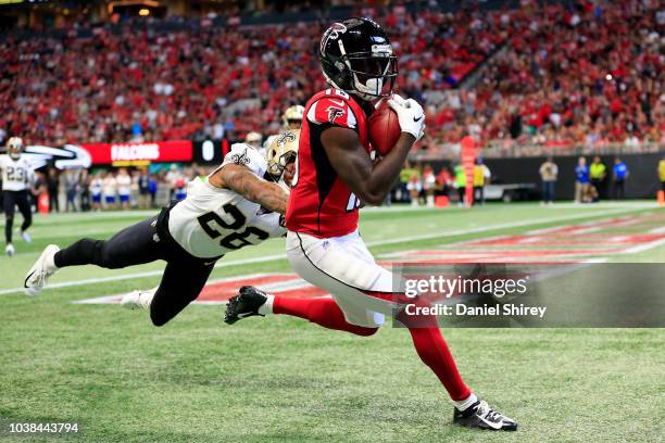 Calvin Ridley of the Atlanta Falcons catches a touchdown pass over P.J. Williams of the New Orleans Saints during the first half at Mercedes-Benz...