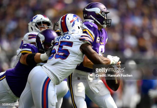 Jerry Hughes of the Buffalo Bills strips the ball out of the hands of Kirk Cousins of the Minnesota Vikings in the first quarter of the game at U.S....