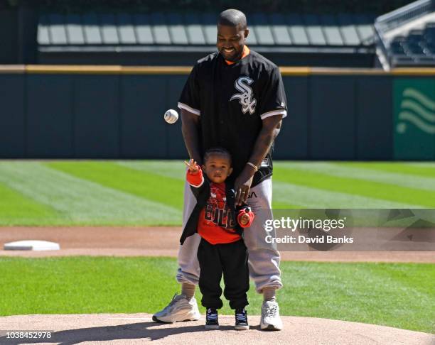 Kanye West and his son Saint throw out a ceremonial first pitch before the game between the Chicago White Sox and the Chicago Cubs on September 23,...