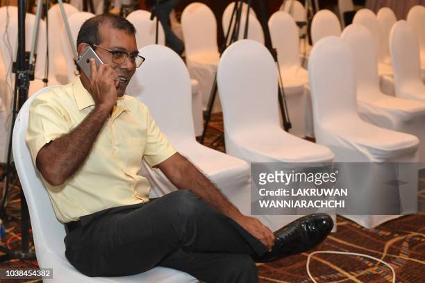 Former President of the Maldives Mohamed Nasheed speaks on the phone at a hotel in Colombo on September 23, 2018 as his candidate Ibrahim Mohamed...