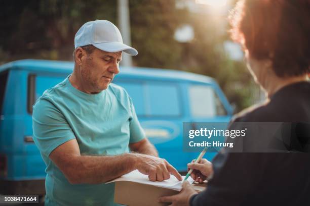sign just here please - elderly receiving paperwork stock pictures, royalty-free photos & images