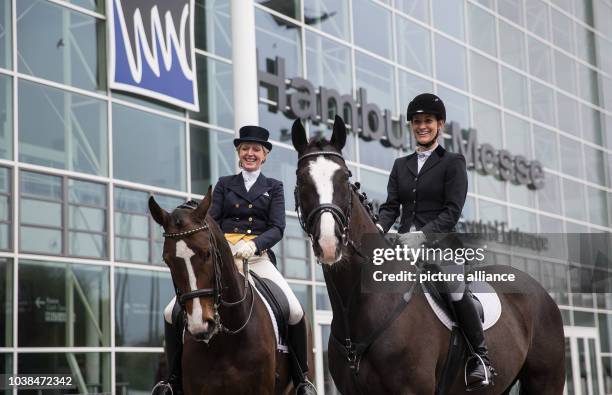 Bianca Groissl Faerber on her horse Eschnapur and Kerstin Schneider Dolly Parton ride past the exhibition center in Hamburg, Germany, 24 April 2014....