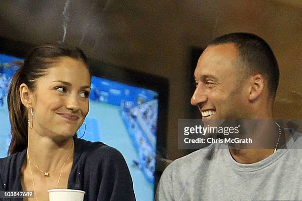 Actress Minka Kelly and Derek Jeter of the New York Yanklees watch as Novak Djokovic of Serbia plays against James Blake of the United States during...