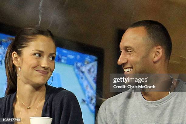 Actress Minka Kelly and Derek Jeter of the New York Yanklees watch as Novak Djokovic of Serbia plays against James Blake of the United States during...