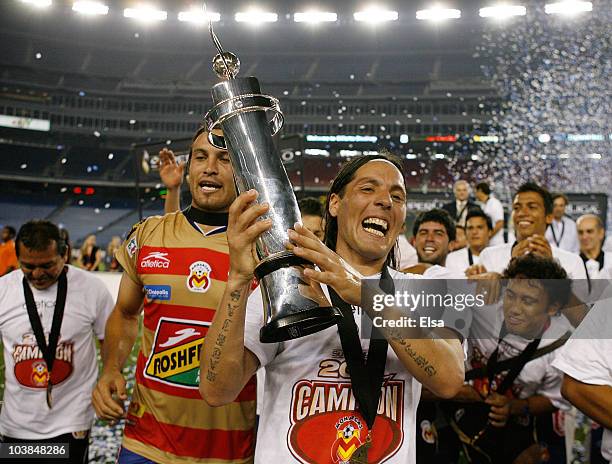 Hugo Droguet of Monarcas Morelia celebrates with the trophy after they won SuperLiga 2010 championship game on September 1, 2010 at Gillette Stadium...