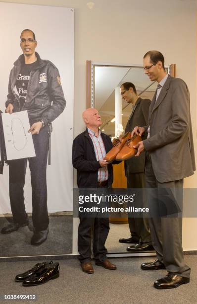 Brahim Takioullah , the world's second tallest person at 2.46 metres, gets size 60 shoes from shoemaker Georg Wessels in Vreden, Germany, 29...