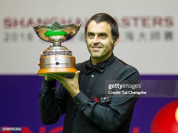 Ronnie O'Sullivan of England poses with his trophy after winning the final match against Barry Hawkins of England on day seven of 2018 Shanghai...