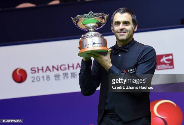 Ronnie O'Sullivan of England poses with his trophy after winning the final match against Barry Hawkins of England on day seven of 2018 Shanghai...