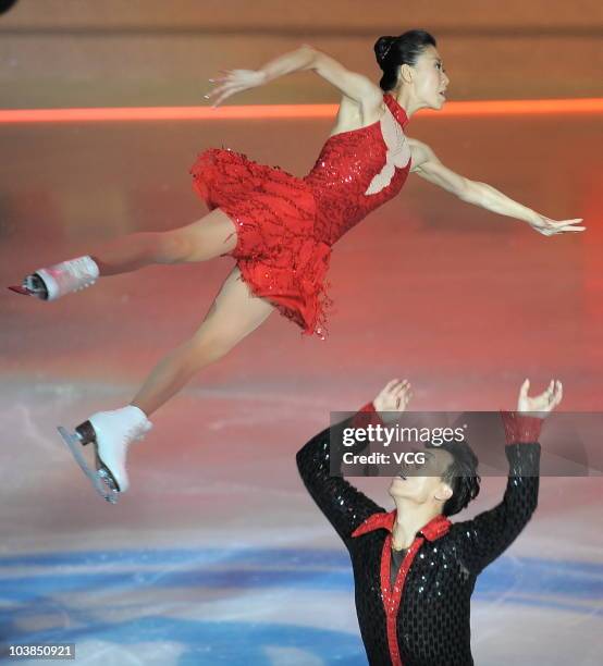 China's first Olympic champion figure skaters Shen Xue and Zhao Hongbo in wedding outfits skate as they enjoy their long-delayed wedding party as...