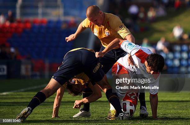 Thomas Broich of the Roar and Ruben Zadkovich of the Jets compete for the ball of the Jets compete for the ball during the round five A-League match...