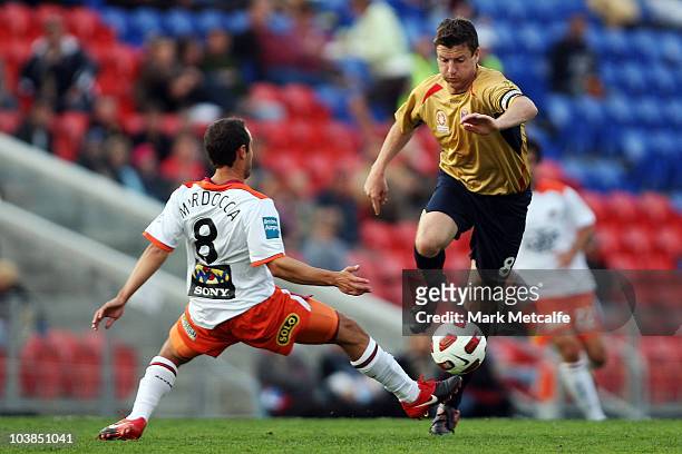 Michael Bridges of the Jets takes on Massimo Murdocca of the Roar during the round five A-League match between the Newcastle Jets and the Brisbane...