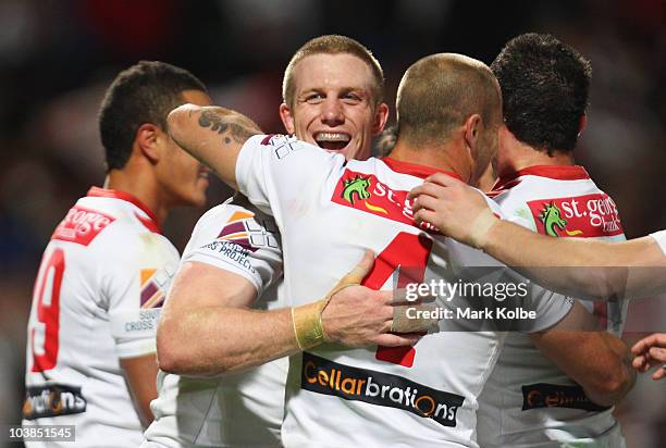 Ben Creagh of the Dragons is congratulated by his team mates after scoring a try during the round 26 NRL match between the St George Illawarra...