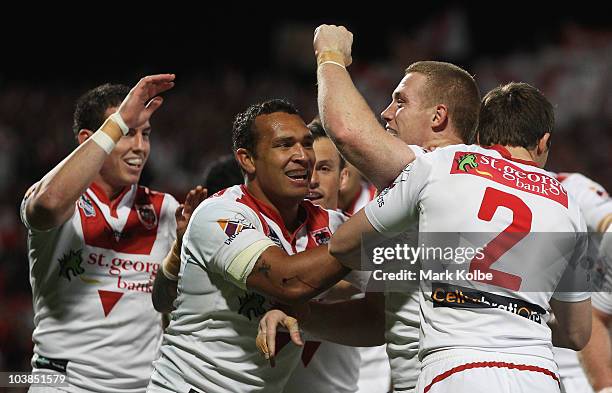 Ben Creagh of the Dragons is congratulated by his team mates after scoring a try during the round 26 NRL match between the St George Illawarra...