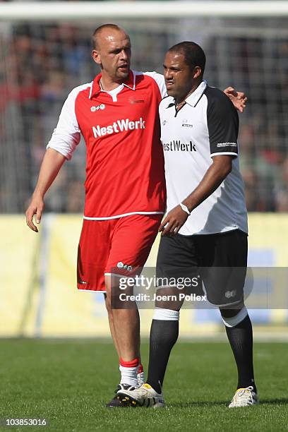 Holger Stanislawski of the team Hamburgtalks to Ailton Hamburg of the team Germany during the Day of Legends match between team Germany and the rest...