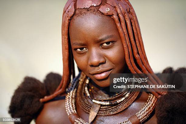Himba woman poses on August 19, 2010 in the village of Otjakati, 40 kms from Opuwo in northern Namibia. AFP PHOTO / STEPHANE DE SAKUTIN