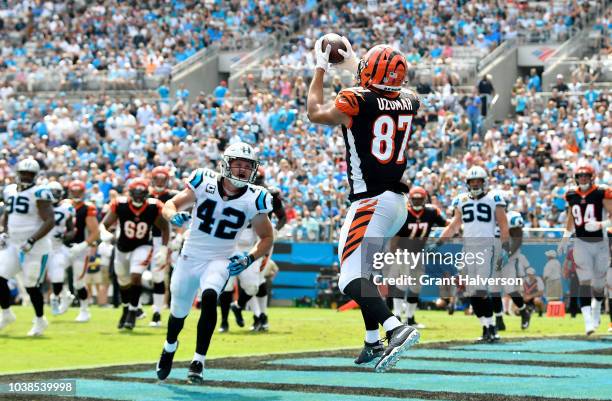 Uzomah of the Cincinnati Bengals catches a touchdown against the Carolina Panthers in the second quarter during their game at Bank of America Stadium...