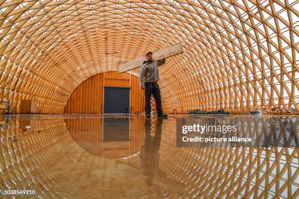 Carpenter Master Eric Bensemann of the company Elite Holzbau standing in his carcass of a production hall made of spruce wood in the industrial park...