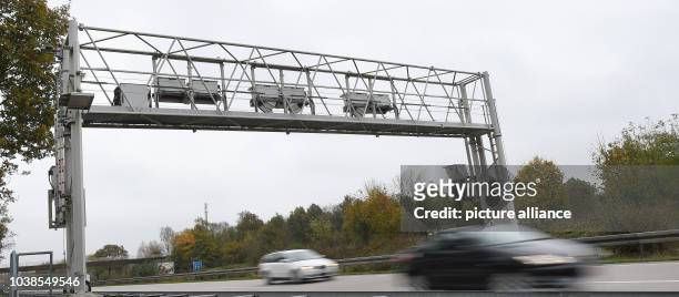 Cars are driven under toll monitoring overhang along Autobahn 353 north of Hanover, Germany, 30 October 2014. The German Transport Ministry plans on...