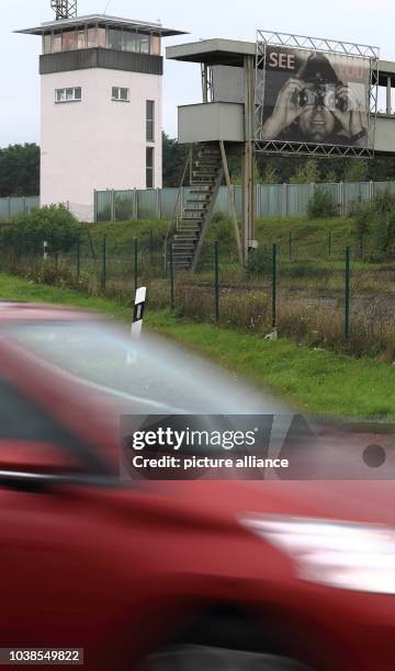 Cars on Autobahn A2 pass by the renovated conning tower and the special inspection bridge of the 'Gedenkstaette Deutsche Teilung Marienborn' division...