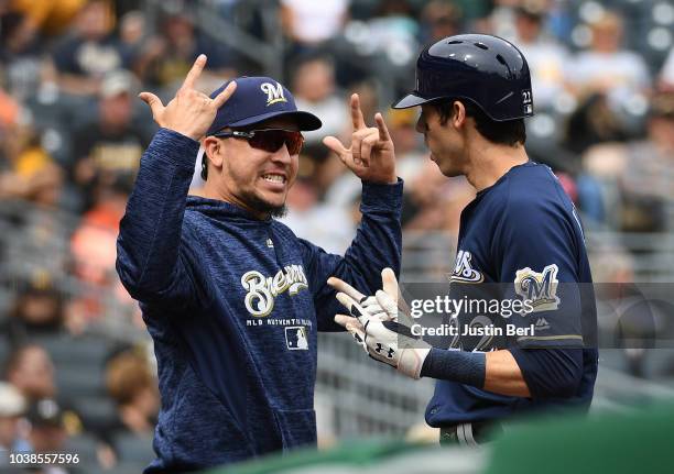 Christian Yelich of the Milwaukee Brewers celebrates with Hernan Perez after Yelich's three-run home run in the second inning during the game against...