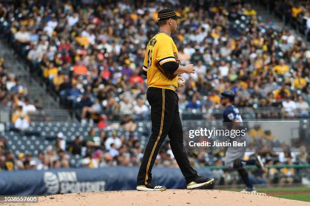 Nick Kingham of the Pittsburgh Pirates reacts as Travis Shaw of the Milwaukee Brewers rounds the bases after hitting a three-run home run in the...