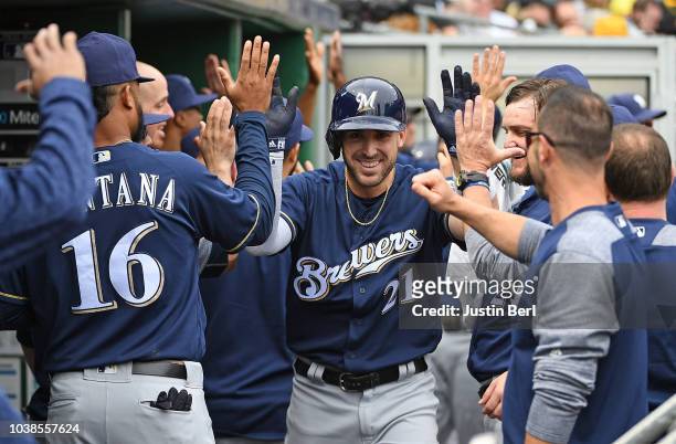 Travis Shaw of the Milwaukee Brewers celebrates with teammates in the dugout after hitting a two-run home run in the second inning during the game...