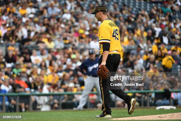 Nick Kingham of the Pittsburgh Pirates walks off the mound after being pulled in the second inning during the game against the Milwaukee Brewers at...