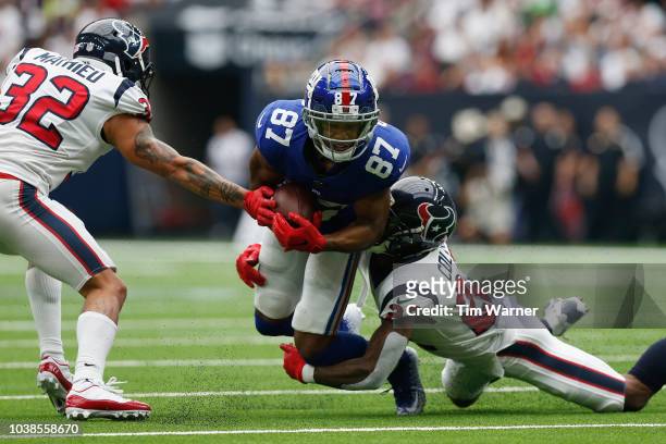 Sterling Shepard of the New York Giants is tackled by Aaron Colvin of the Houston Texans in the second quarter at NRG Stadium on September 23, 2018...