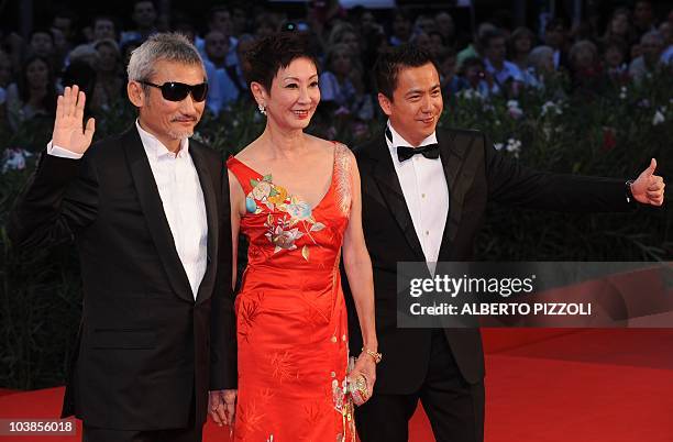 Chinese film director Tsui Hark, film producer Nansun Shi and producer Zhonglei Wang arrive for the screening of "Di renjie zhi tongtian diguo " at...