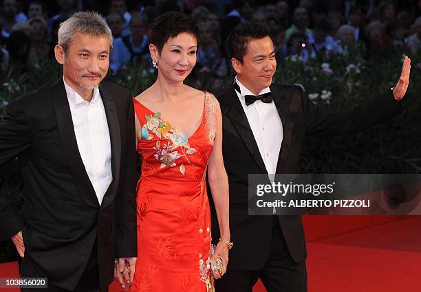 Chinese film director Tsui Hark, film producer Nansun Shi and producer Zhonglei Wang arrive for the screening of "Di renjie zhi tongtian diguo " at...