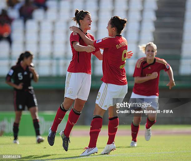 Lena Lotzen of Germany celebrates with team-mate Kyra Malinowski after scoring the first goal during the FIFA U17 Women's World Cup Group A match...