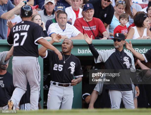 Ramon Castro of the Chicago White Sox is congratulated by Andruw Jones after Castro scored the game winning run on a bases loaded walk in the ninth...