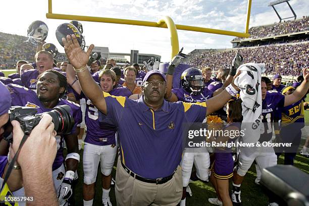 East Carolina new head coach Ruffin McNeill and the team recognize the cheering fans after an exciting end of an NCAA college football game against...